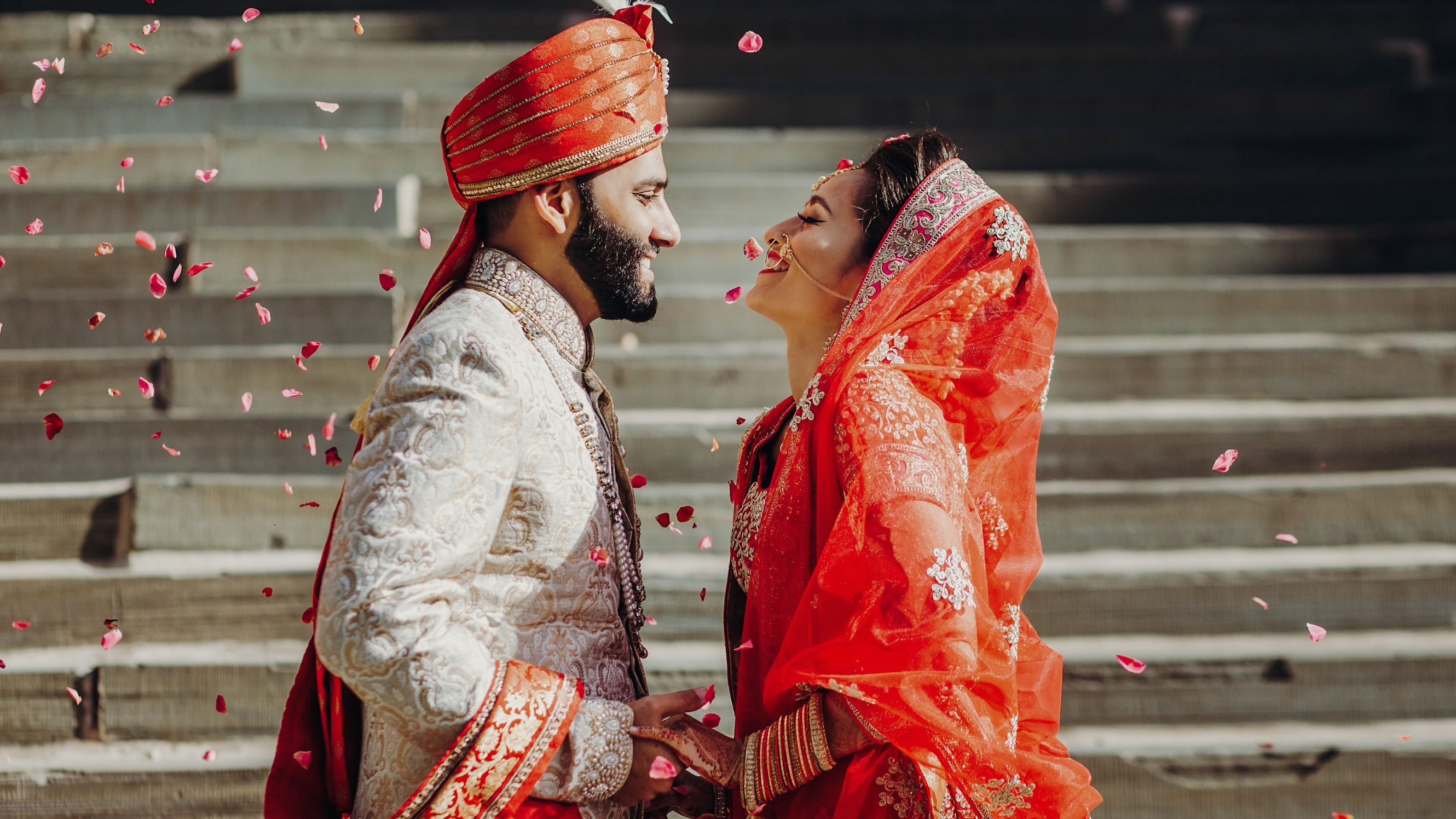 A couple looks at themselves with confetti around